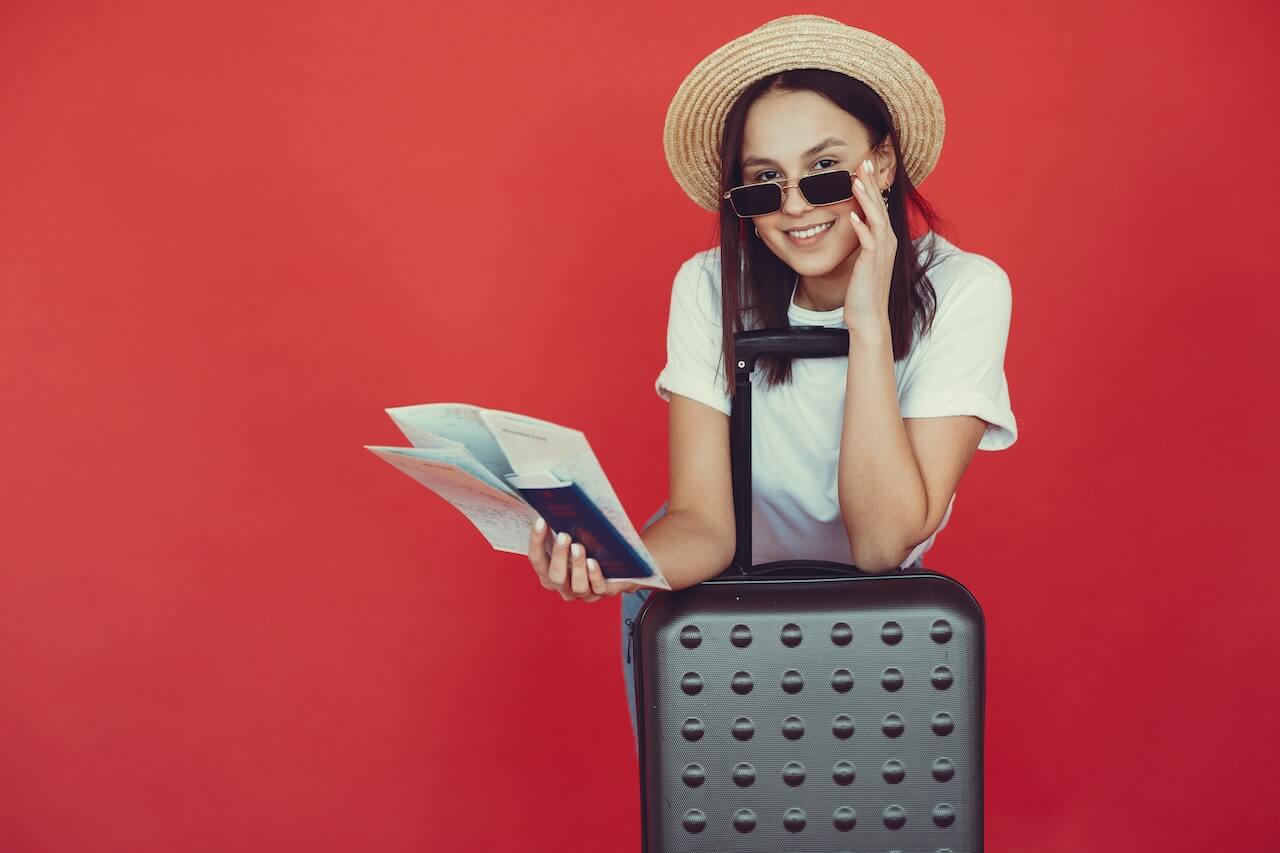 Teenager holding passport and suitcase 