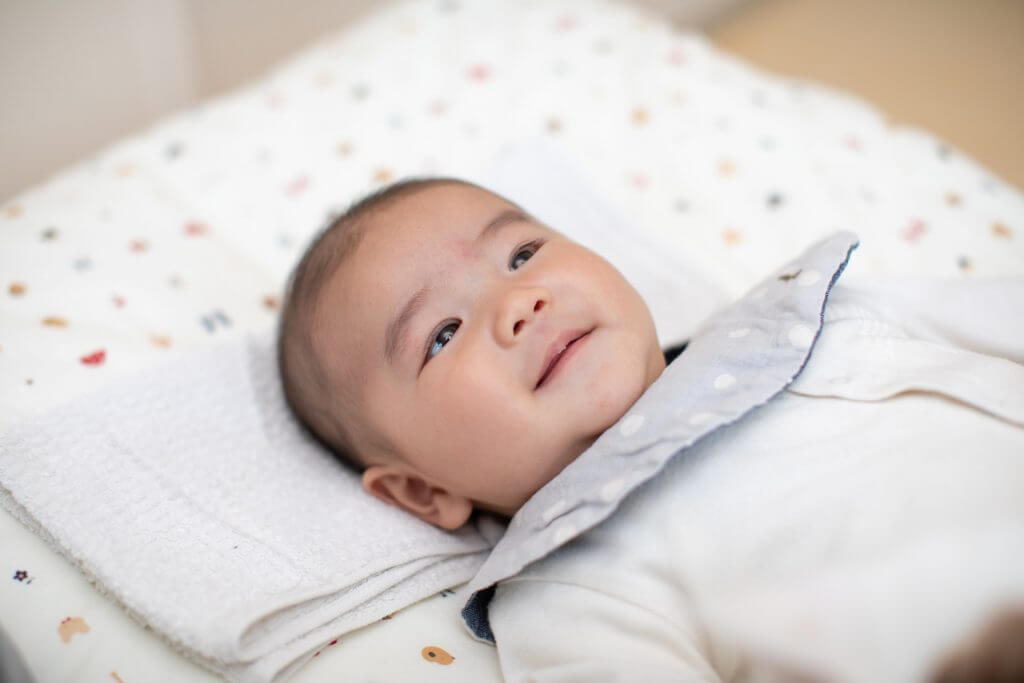 a baby lying on the bed