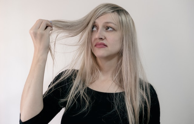 A woman is holding her hair