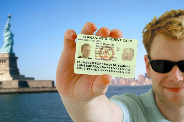 a man holding a US permanent resident card