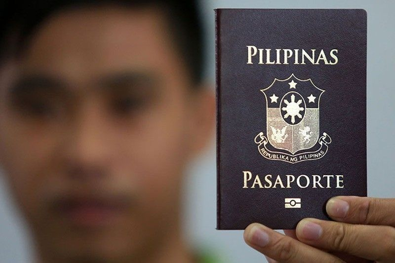 a man holding a Philippine passport