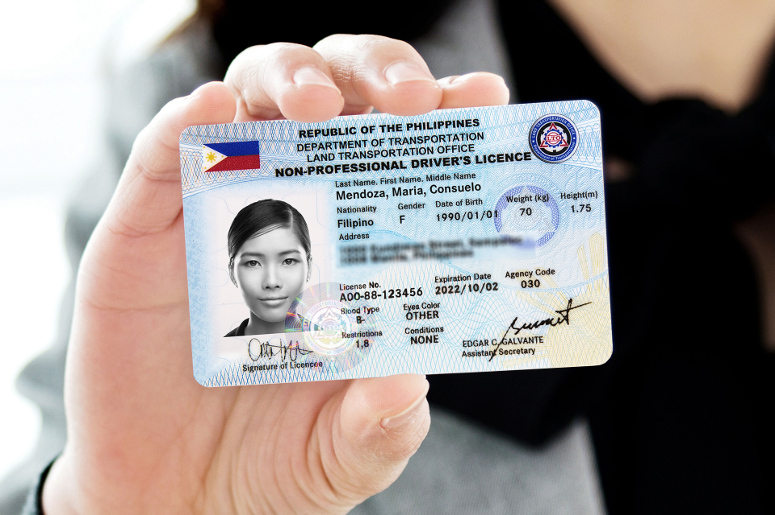 A man holding a Philippine driver's license