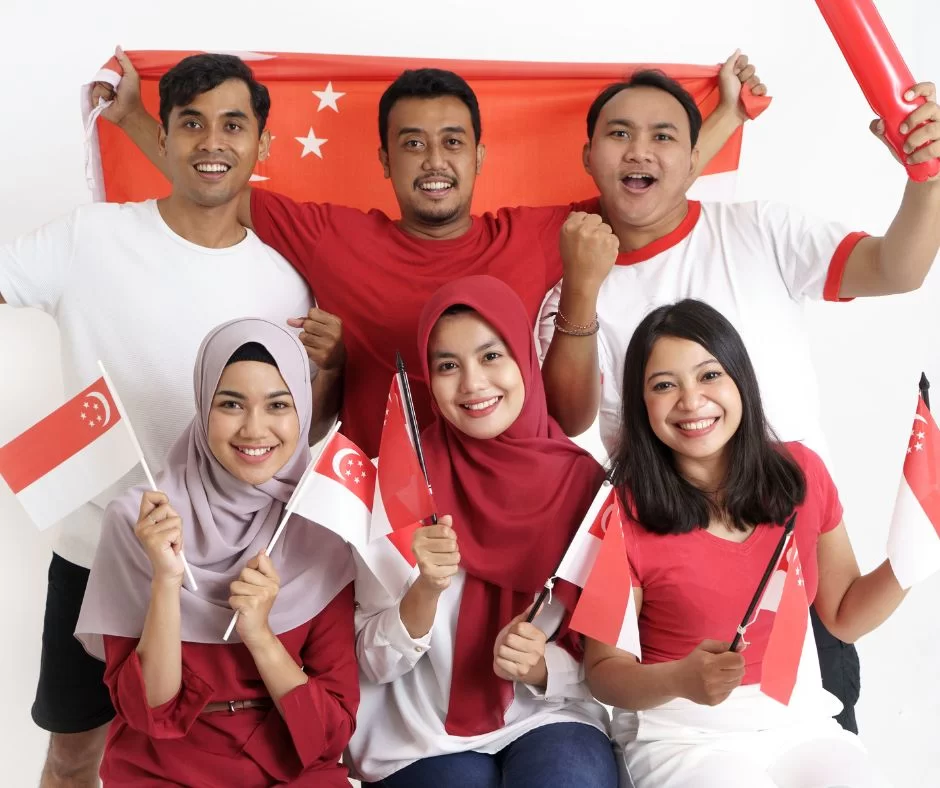 a group of human holding Singapore National flags