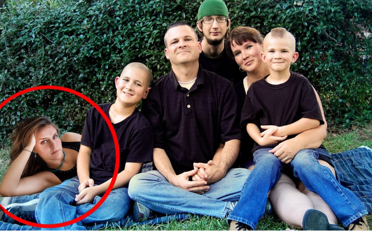 A group of people sitting on grass